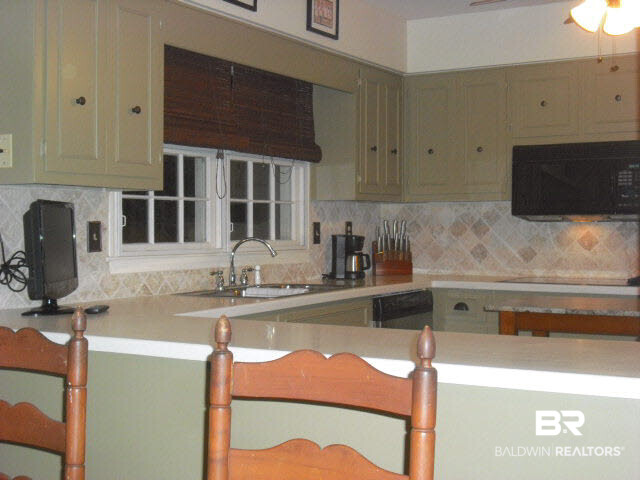 6156 Brandy Run Road South Mobile, AL 36608 - Photo 3 of 16 Kitchen is spacious with lots of cabinets, Tiled Backsplash, Deep sink w/window view to the backyard, Pantry, Broom Closet, Hardwood Floors, Stainless Steel Appliances.