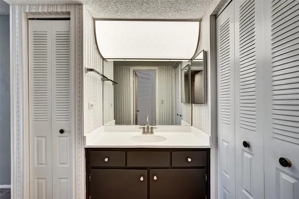 a view of a kitchen with a sink and a refrigerator