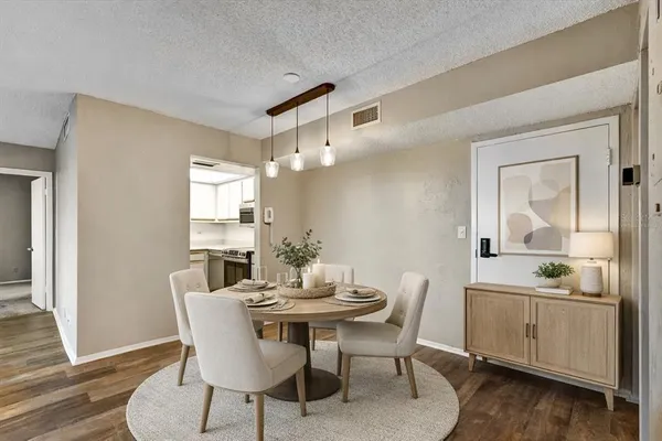 a view of a dining room with furniture and wooden floor