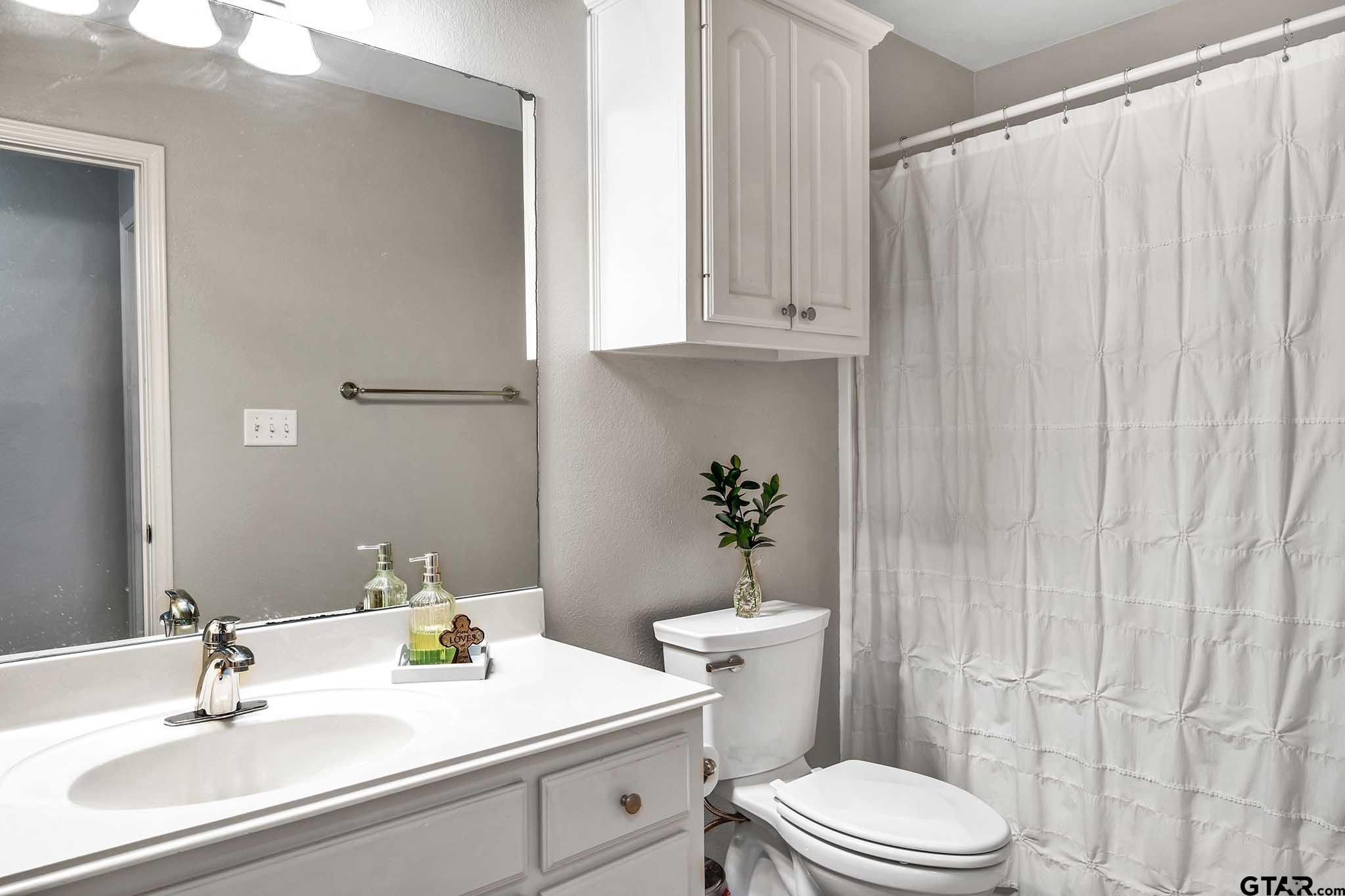 101 Collin Drive Chandler, TX 75758 - Photo 19 of 24 a bathroom with a sink a toilet and tub