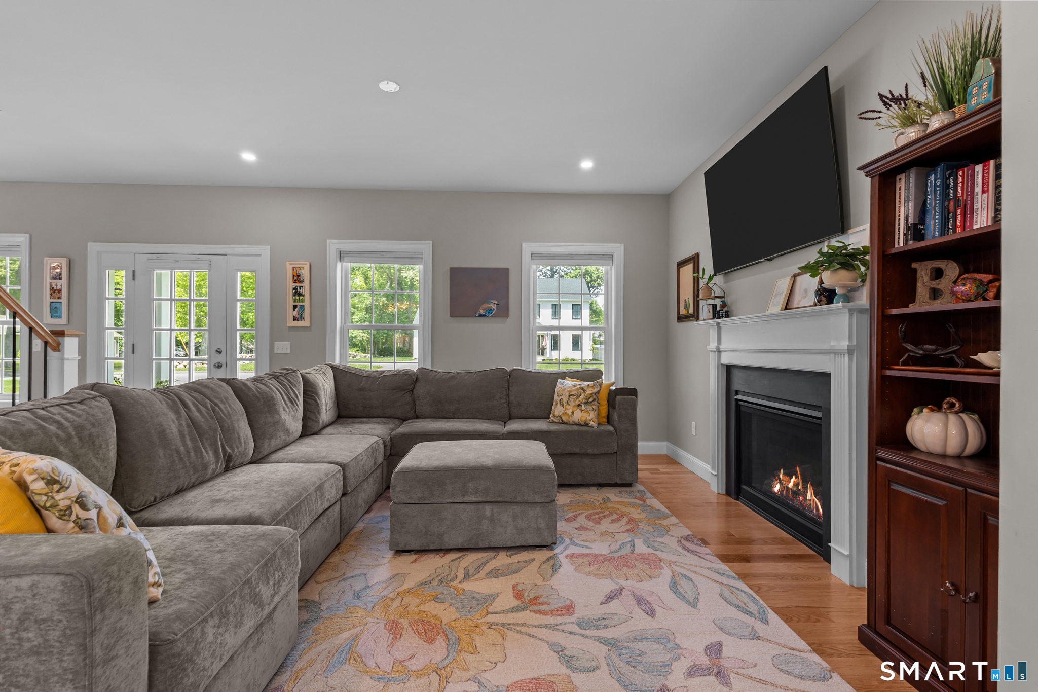 2 Martys Way Gales Ferry, CT 06335 - Photo 3 of 40 a living room with furniture a fireplace and a book shelf