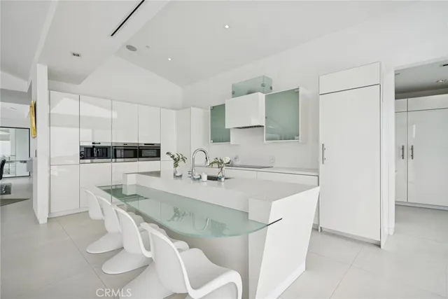 a kitchen with sink refrigerator and stove