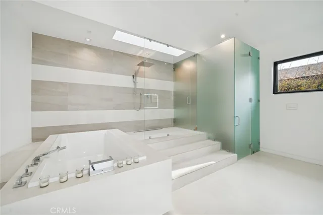 a large bed sitting in a bedroom next to a window