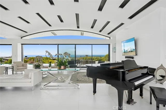 a living room with patio furniture and a floor to ceiling window