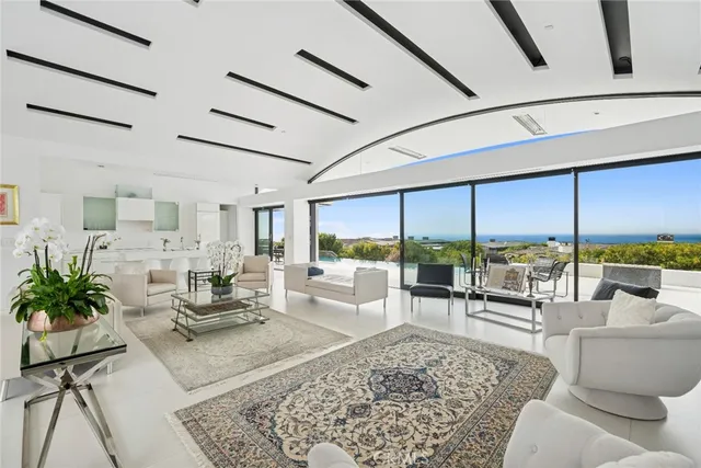 a large white open kitchen with a large window