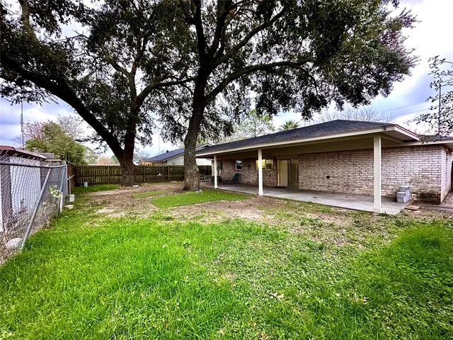 a backyard of a house with table and chairs