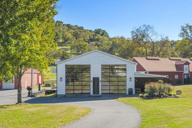a front view of house with yard and trees in the background