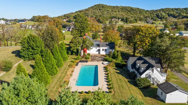 a view of a house with a yard and sitting area