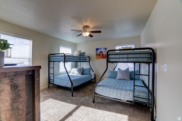 3853 South Red Valley Circle, Unit 22A1 Moab, UT 84532 - Photo 17 of 28 Bedroom with carpet floors and ceiling fan