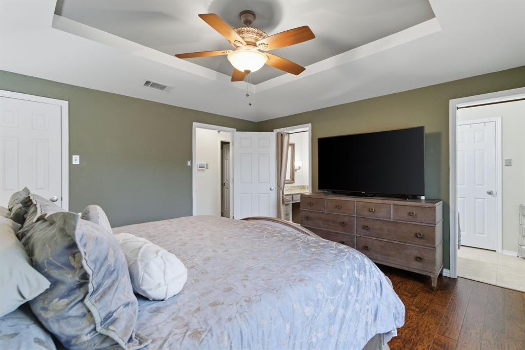 2307 Castle Rock Road Carrollton, TX 75007 - Photo 21 of 34 This room features hardwood flooring, a tray ceiling with a ceiling fan, and painted walls