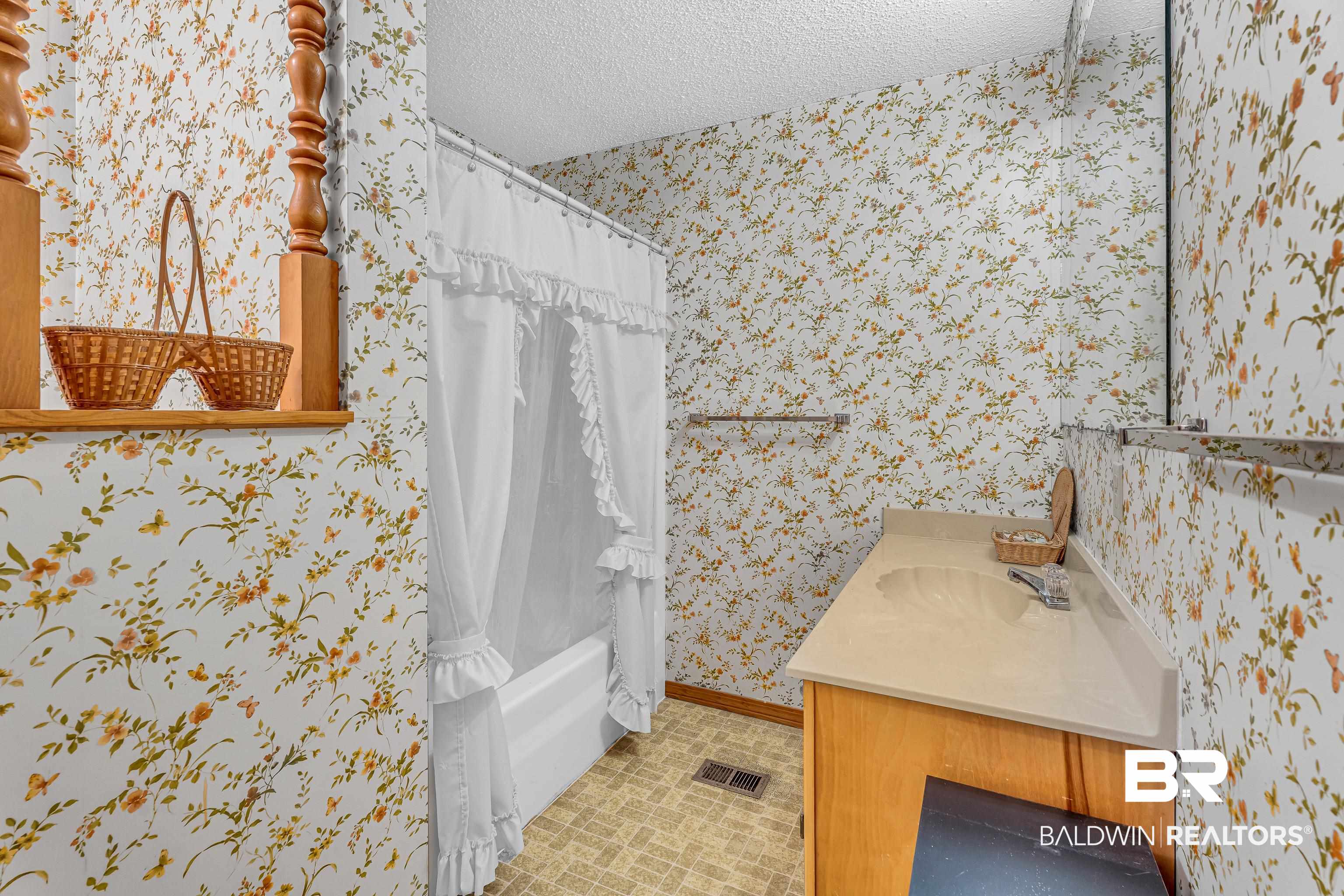 72075 Highway 59 Little River, AL 36550 - Photo 22 of 40 Bathroom with wallpapered walls, shower / bath combo, vanity, and a textured ceiling