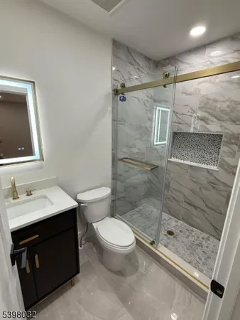 a bathroom with a sink toilet and shower