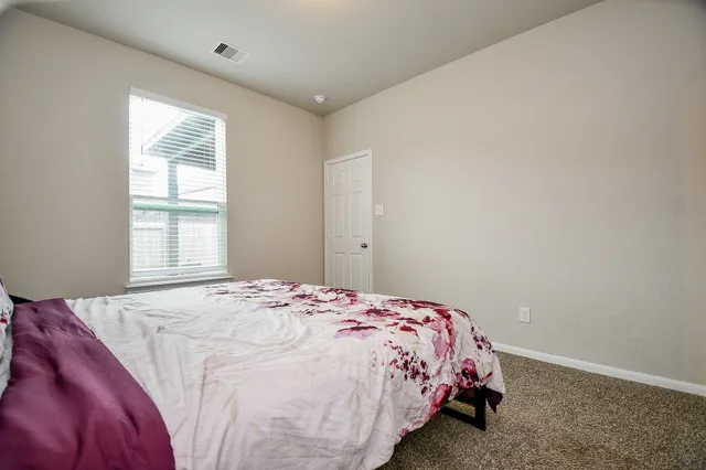 a bedroom with a bed and chair