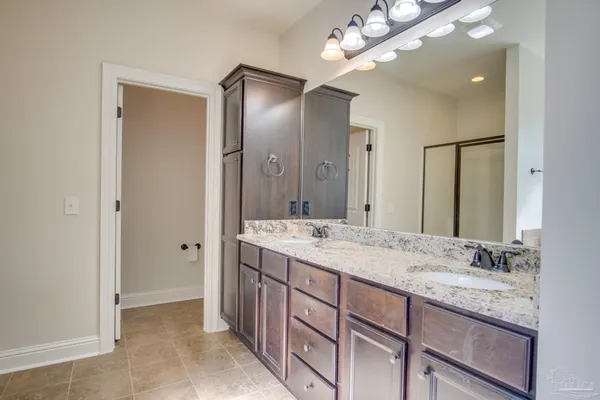a bathroom with a double vanity sink and a mirror