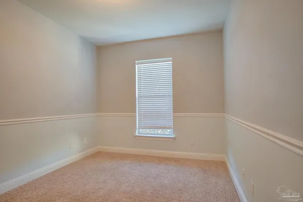 a bathroom with a granite countertop sink a toilet and a mirror