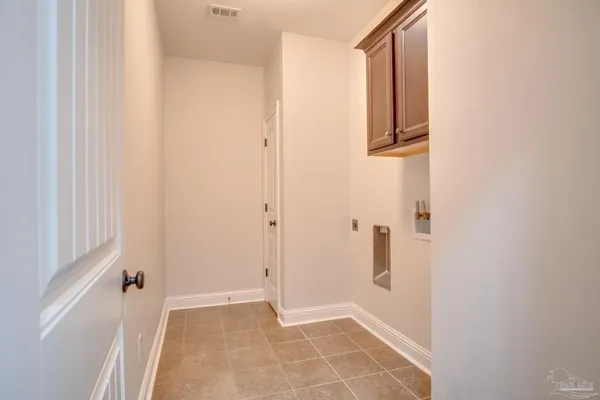 a view of an empty room with a cabinet