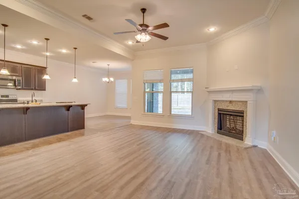 a view of an empty room with a kitchen and a kitchen view