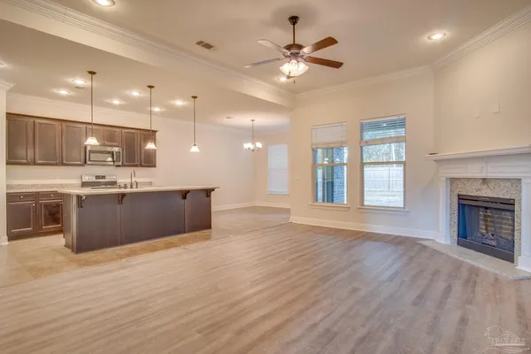 a large kitchen with kitchen island a island wooden floor and a counter top space