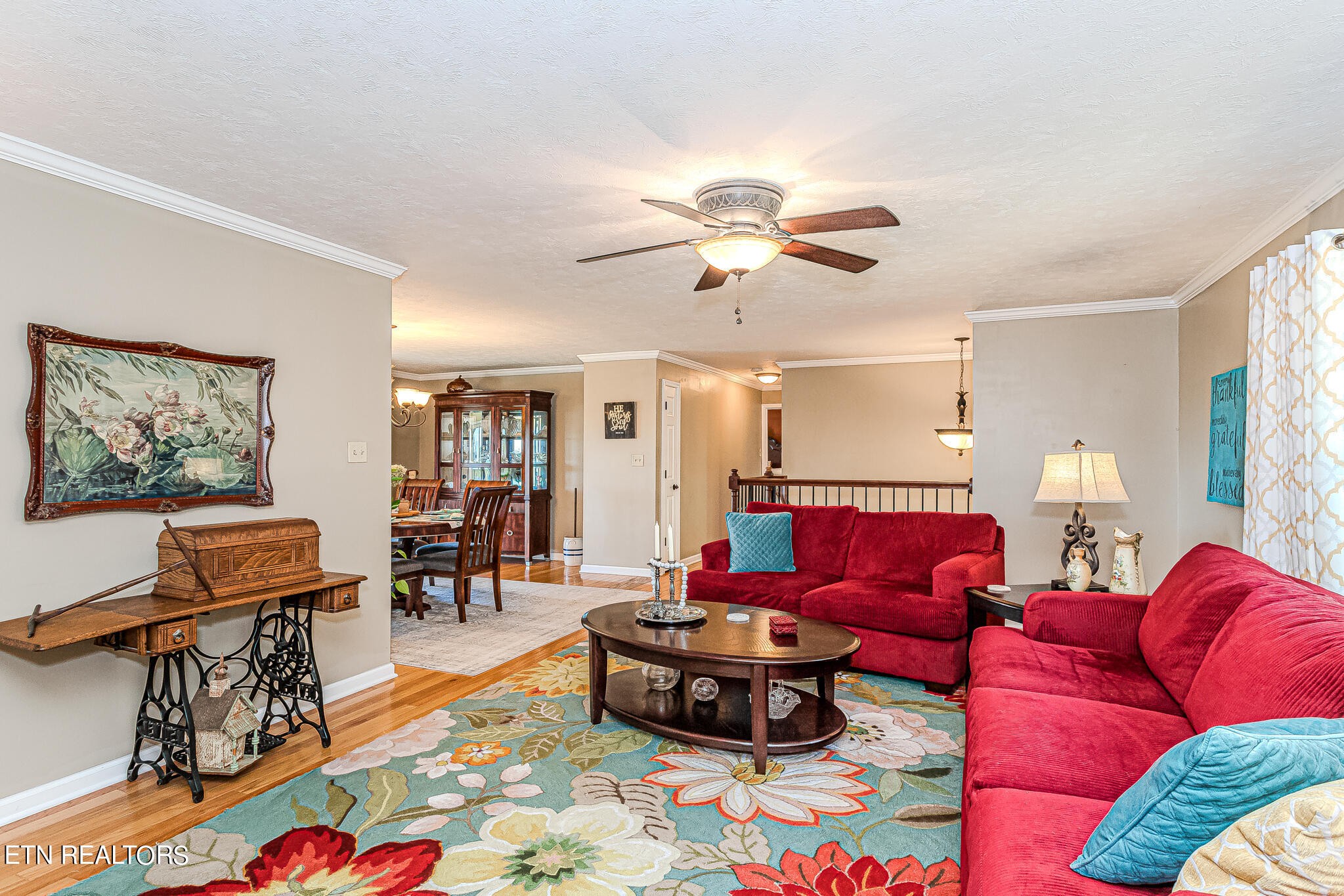 6011 Renee Road Corryton, TN 37721 - Photo 5 of 56 a living room with furniture a dining table and a bookshelf with wooden floor