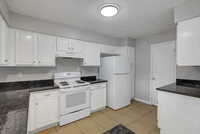 a kitchen with cabinets appliances and a counter space