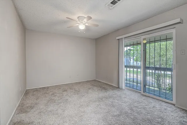 a view of an empty room with windows