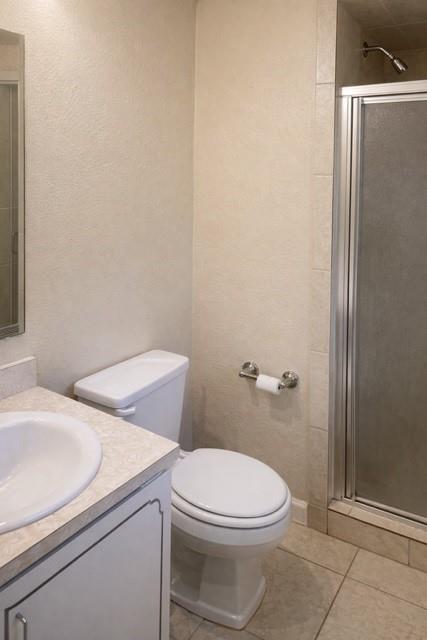6009 Deborah Lane Watauga, TX 76148 - Photo 11 of 13 a white toilet sitting next to a bathroom sink