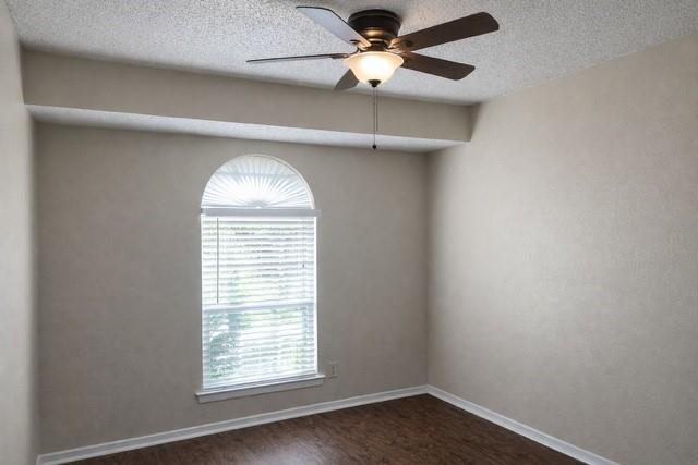 6009 Deborah Lane Watauga, TX 76148 - Photo 9 of 13 an empty room with a window and a fan