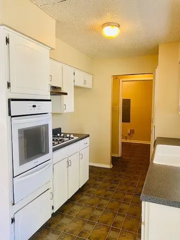 a kitchen with a sink and a window