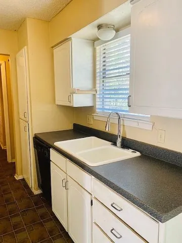 a kitchen with a sink and a refrigerator