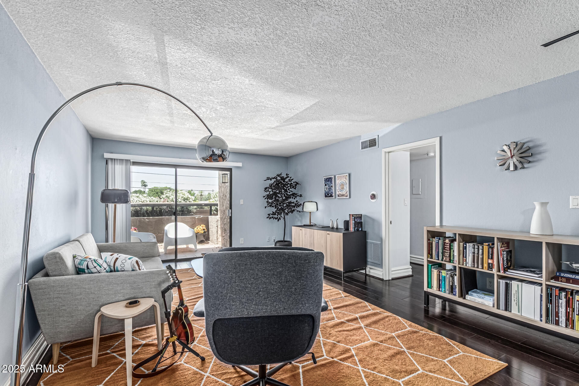 a living room with furniture and a book shelf