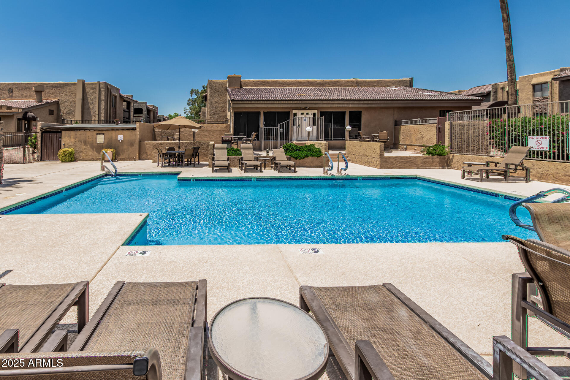 3825 East Camelback Road, Unit 152 Phoenix, AZ 85018 - Photo 14 of 28 a view of a swimming pool with outdoor seating
