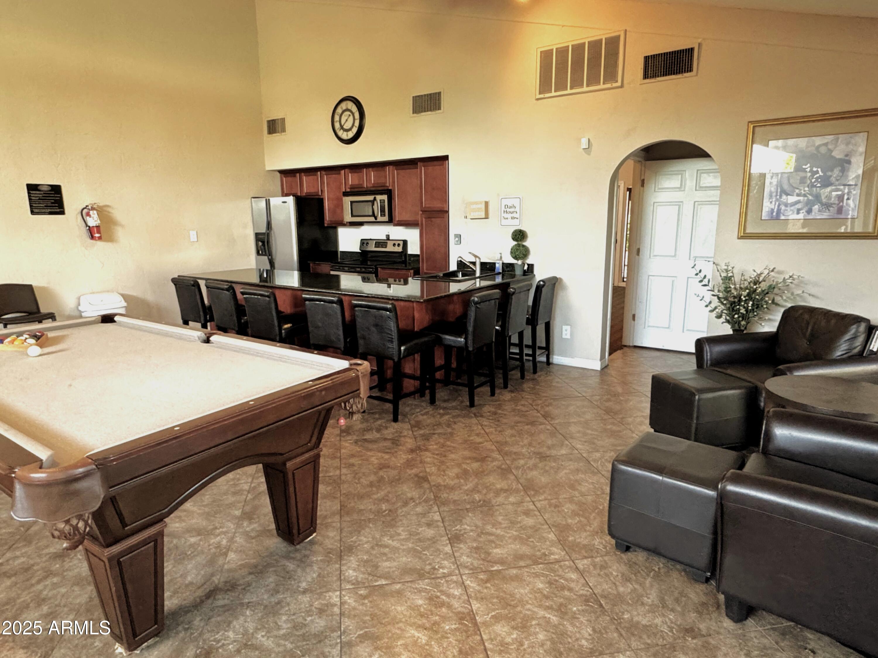 3825 East Camelback Road, Unit 152 Phoenix, AZ 85018 - Photo 18 of 28 a living room with furniture a flat screen tv and a table