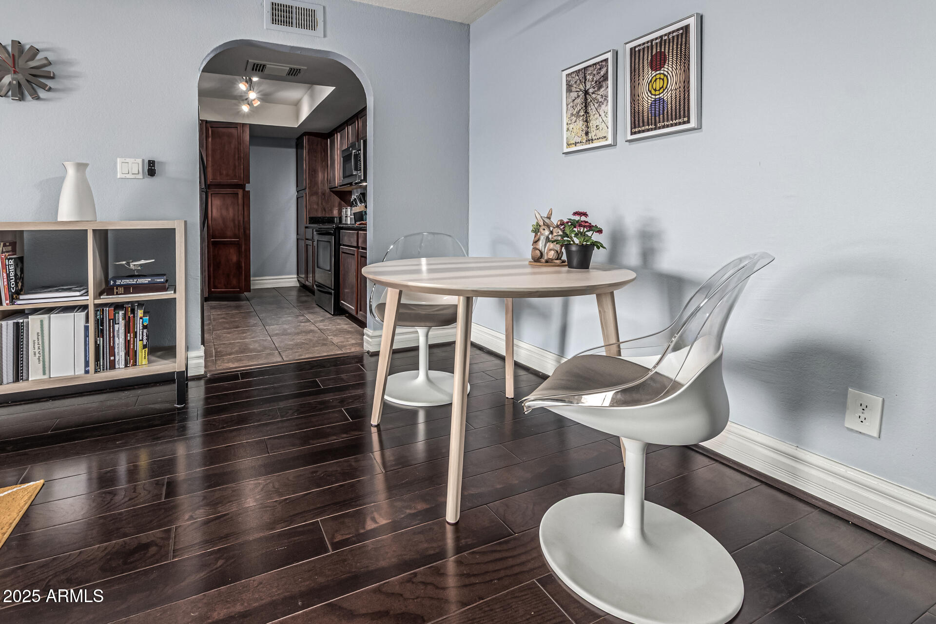 3825 East Camelback Road, Unit 152 Phoenix, AZ 85018 - Photo 2 of 28 a view of a dining room with furniture a chandelier and wooden floor