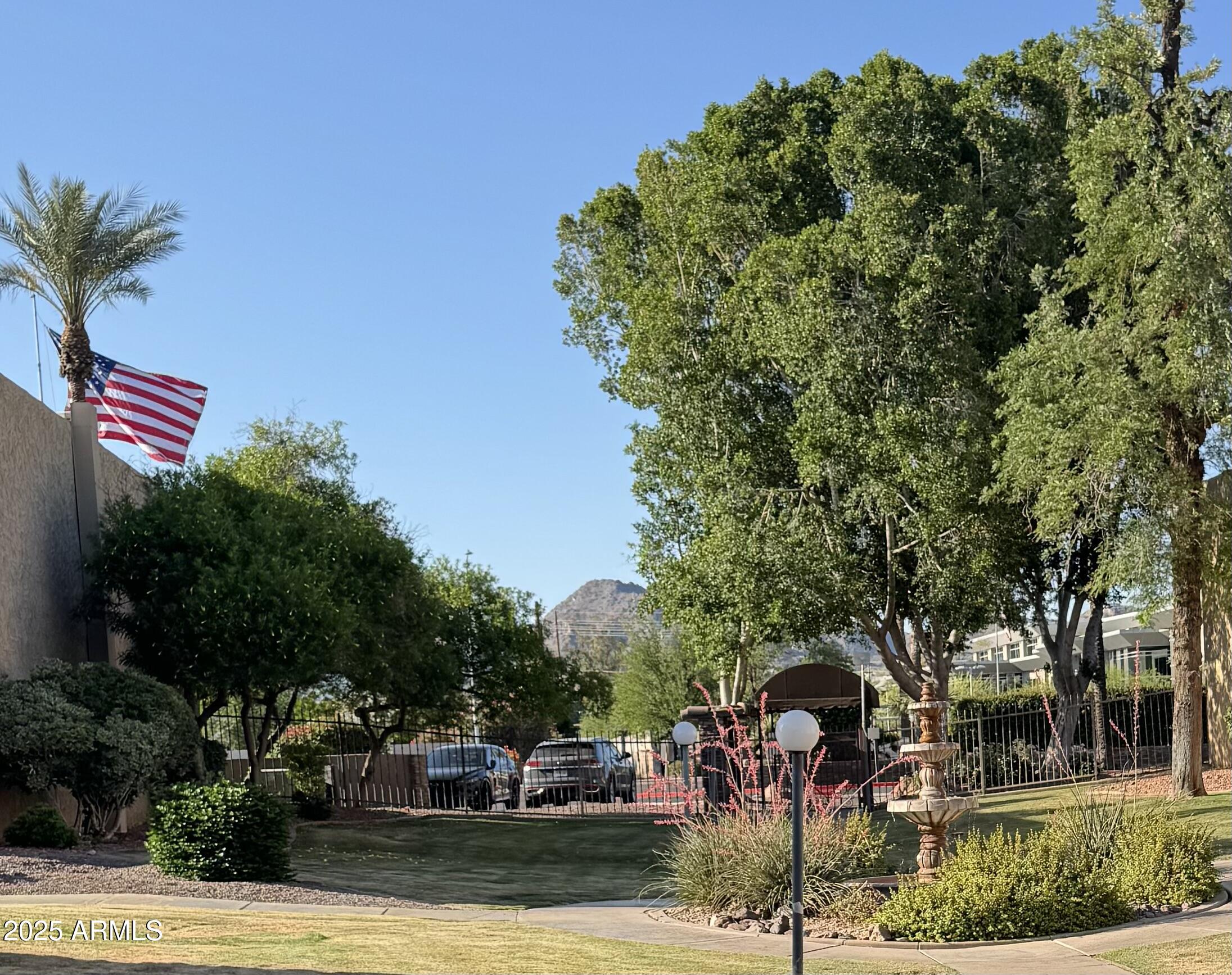 3825 East Camelback Road, Unit 152 Phoenix, AZ 85018 - Photo 23 of 28 a front view of a house with a yard