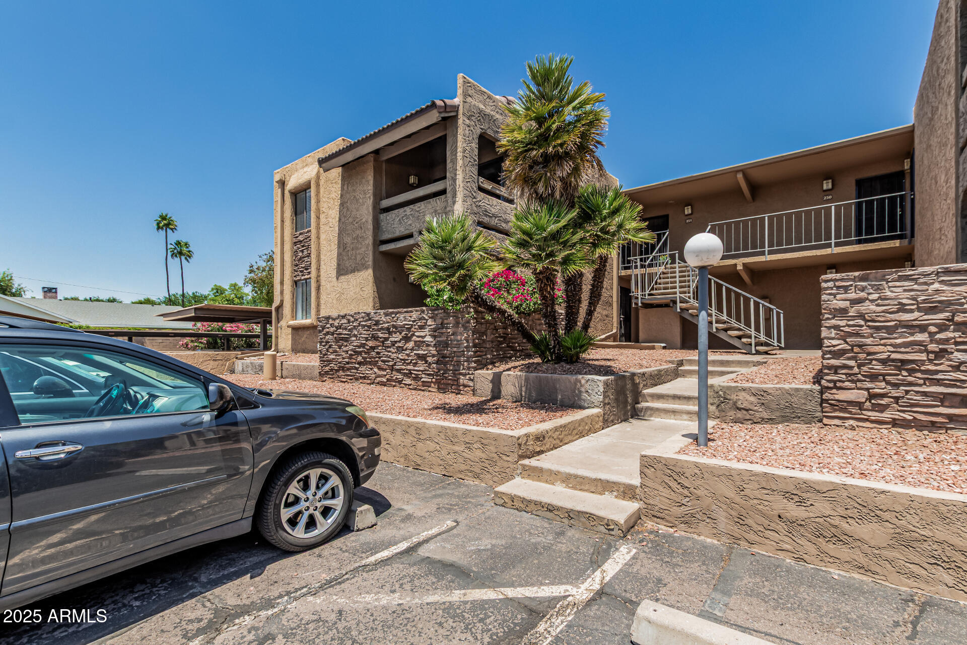 3825 East Camelback Road, Unit 152 Phoenix, AZ 85018 - Photo 24 of 28 a car parked in front of a house
