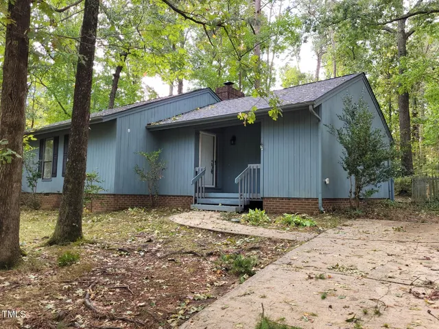 a house with a tree in front of it