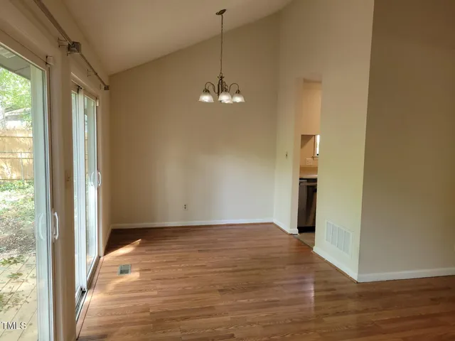 a view of a room with wooden floor and windows