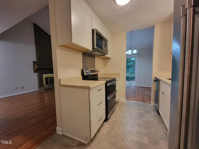 a kitchen with a stove and a refrigerator
