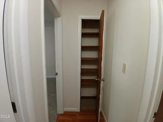 a view of walk in closet with empty racks
