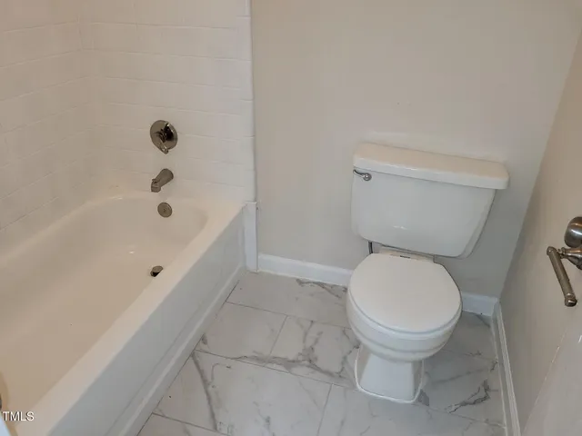 a bathroom with a toilet and a bathtub