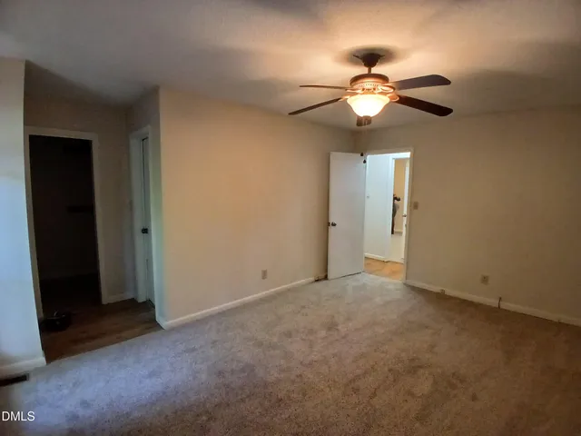 a view of a chandelier fan and entryway