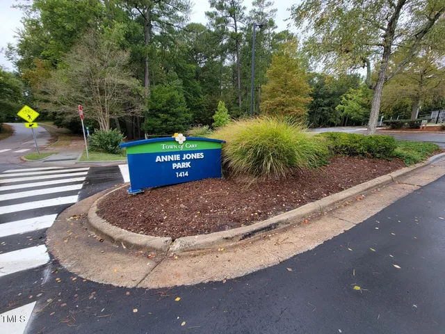 a view of a yard with table and chairs potted plants