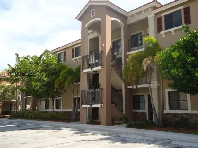 a front view of a building with a garden