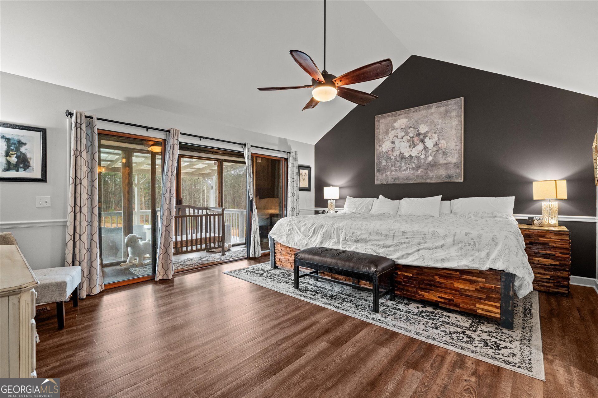 620 Smyrna Church Road Carrollton, GA 30117 - Photo 22 of 68 a bedroom with a bed a dresser and wooden floor