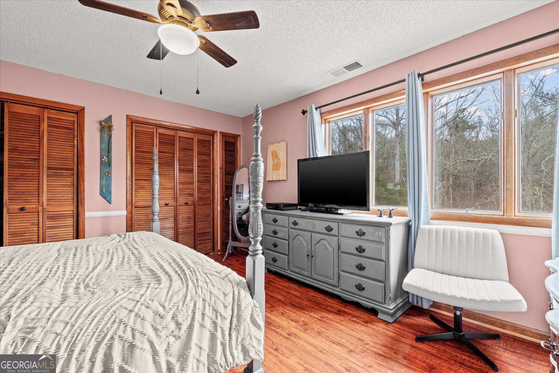 620 Smyrna Church Road Carrollton, GA 30117 - Photo 34 of 68 a bedroom with a bed and a flat screen tv on dresser