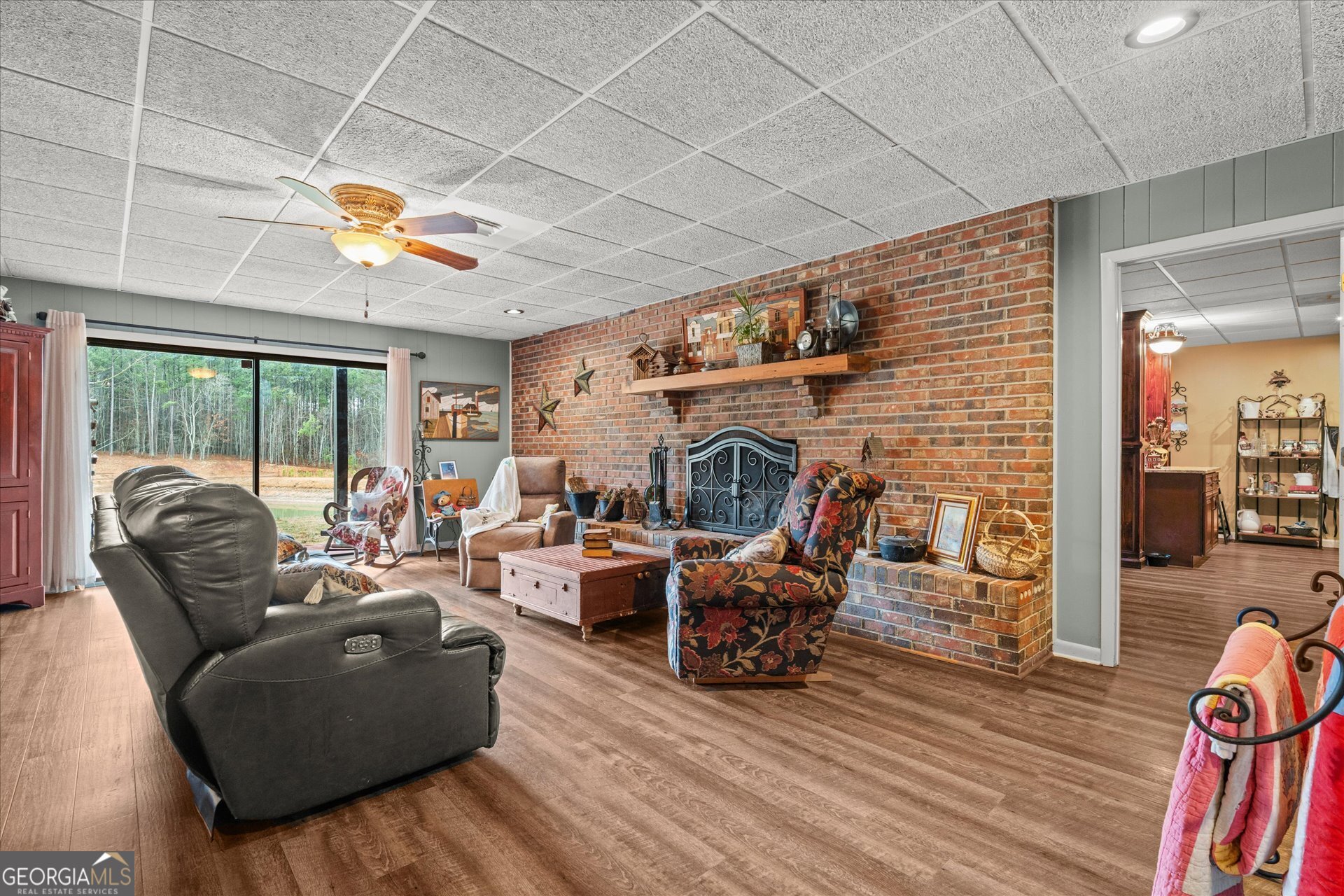 620 Smyrna Church Road Carrollton, GA 30117 - Photo 41 of 68 a living room with furniture a fireplace and a floor to ceiling window