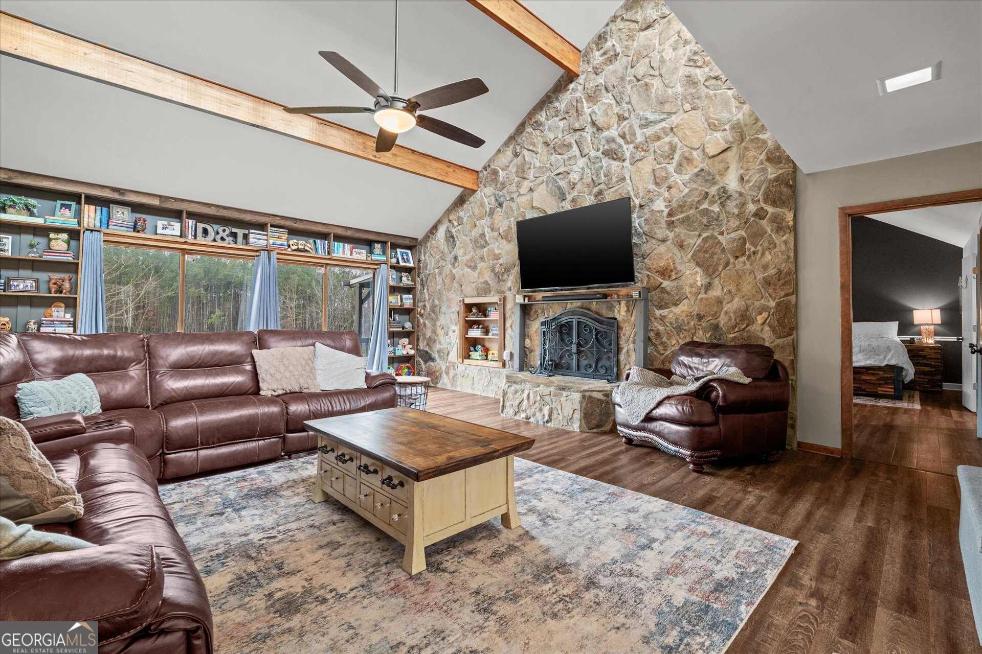 620 Smyrna Church Road Carrollton, GA 30117 - Photo 8 of 68 a living room with furniture a flat screen tv and a fireplace