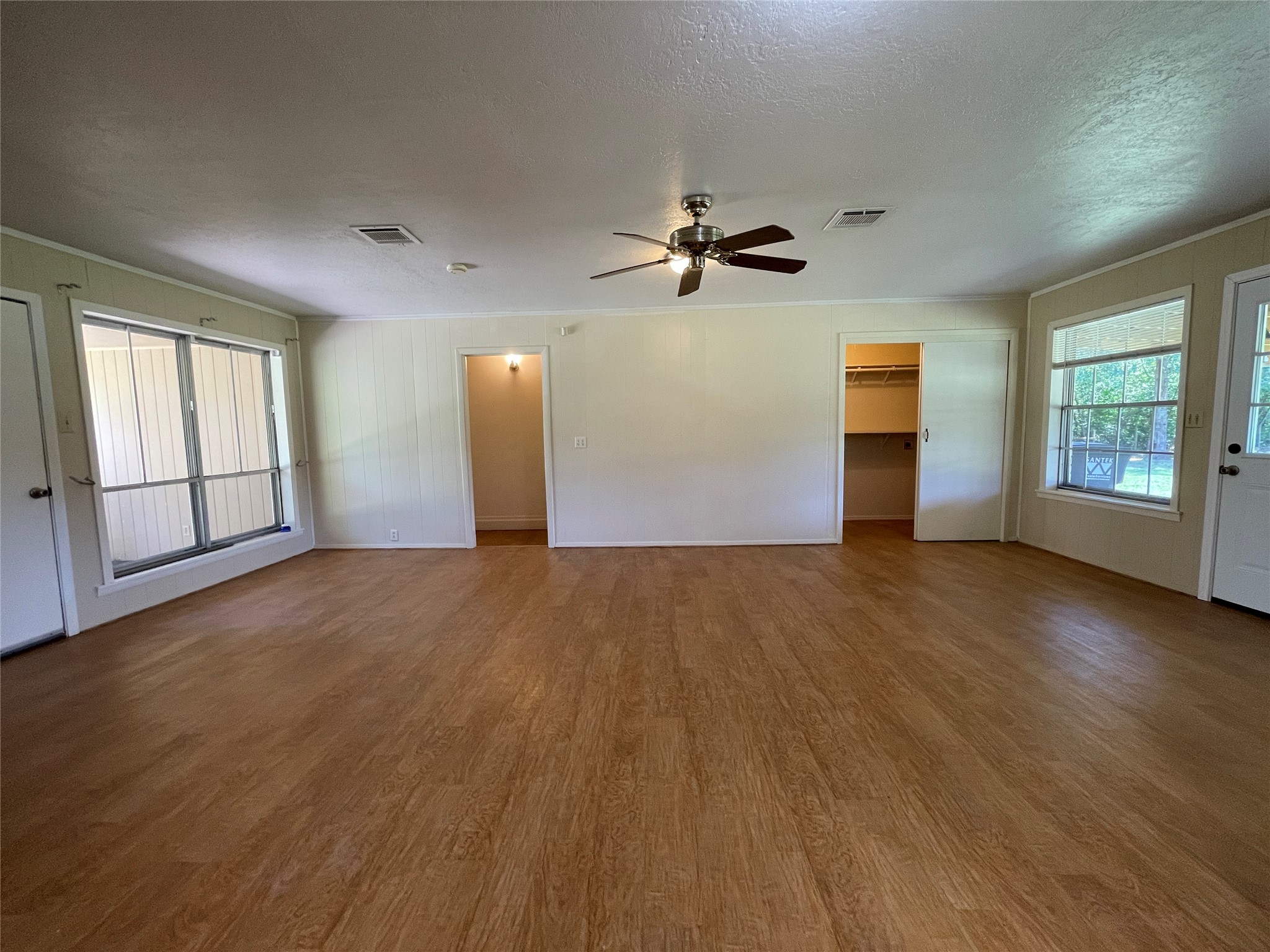 19439 Keenan Cut Off Road Montgomery, TX 77316 - Photo 7 of 39 a view of empty room with wooden floor and fan