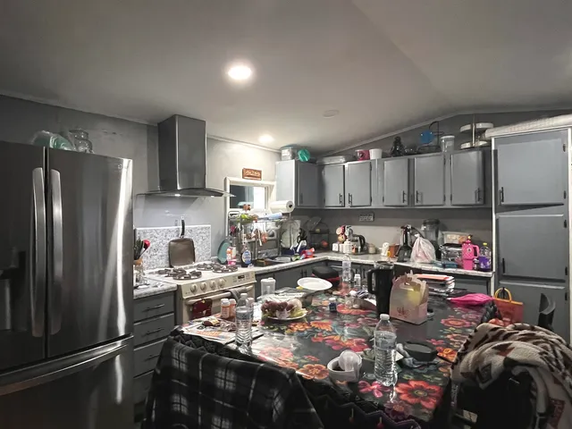 a kitchen with lots of bottles of alcohol
