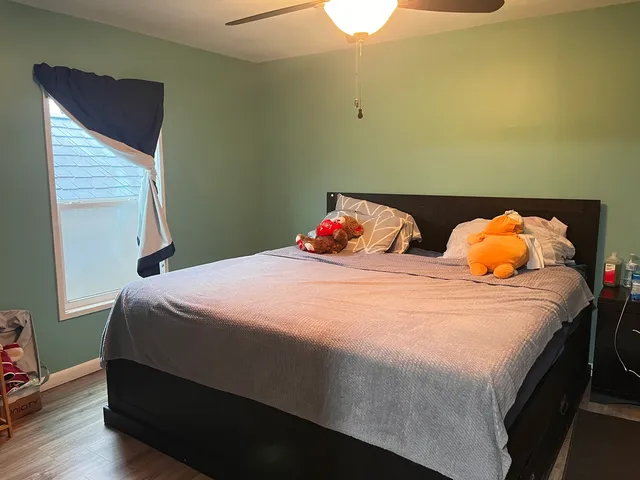 a bedroom with a bed and a window